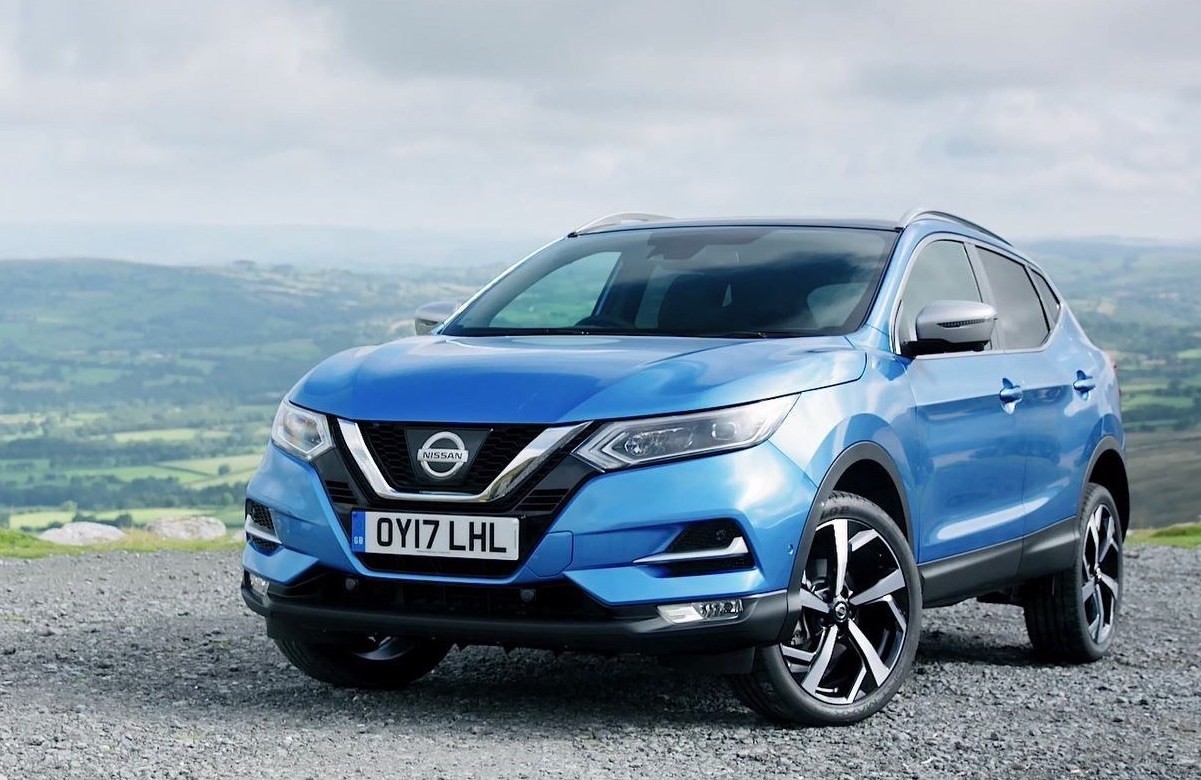 Blue Nissan Qashqai parked overlooking a countryside view.